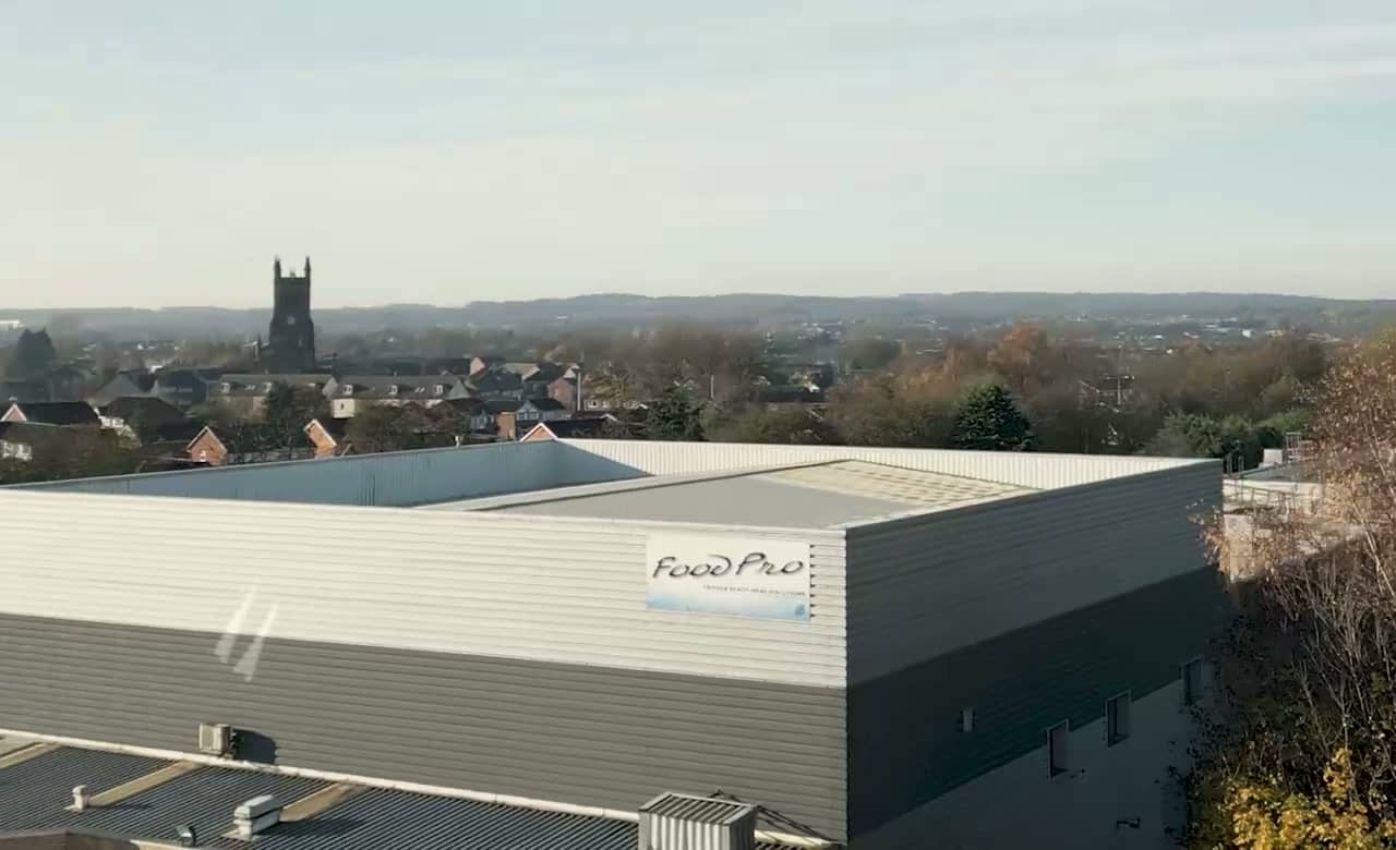 Aerial view of the FoodPro factory roof and sign, with Wigan beyond